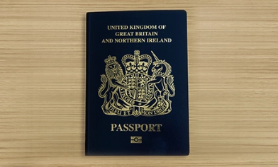 United Kingdom of Great Britain and Northern Ireland biometric passport on wooden surface