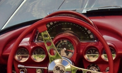 Vintage Chevrolet Corvette red dashboard with red steering wheel with chrome trims